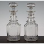 A pair of glass mallet shaped decanters and stoppers, mid 19th century, with triple ring necks and
