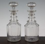 A pair of glass mallet shaped decanters and stoppers, mid 19th century, with triple ring necks and