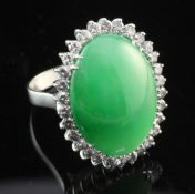 A white gold, cabochon jadeite and diamond ring, of oval form, with Gem & Pearl Laboratory report