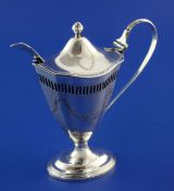 A late Victorian Adams style silver mustard pot, with pierced border, blue glass liner and