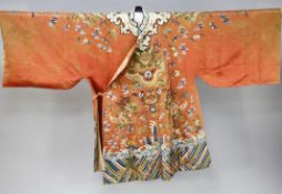A Chinese apricot satin embroidered silk and metal thread dragon robe, late 19th century, woven to