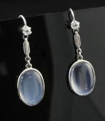 A pair of platinum, moonstone and diamond drop earrings, each set with an oval cabochon moonstone