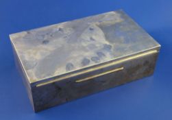 An early 20th century French 950 standard silver rectangular cigarette box, with coromandel wood two