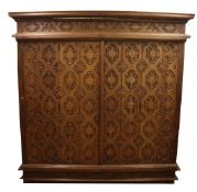 A large Burmese carved hardwood cabinet, with hinged doors revealing fitted drawers, W.7ft 4in.