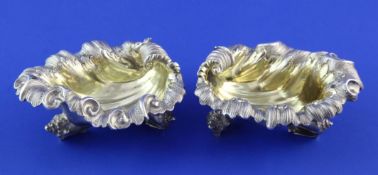 A good pair of Victorian cast silver shell shaped table salts by Edward & John Barnard, with