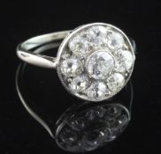 A white gold and diamond cluster target ring, set with nine round cut diamonds, size K.