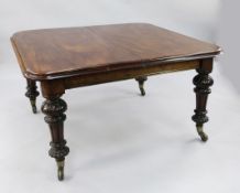 A Victorian mahogany extending dining table, with three extra leaves, on turned and part fluted