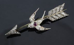 A mid 20th century gold, ruby and diamond set swallow and arrow brooch, set with old and rose cut