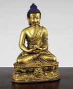 A Sino-Tibetan gilt bronze figure of Sakyamuni Buddha, seated holding a bowl, on a double lotus