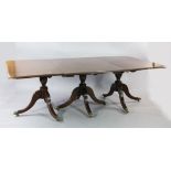 An early 19th century mahogany triple pillar extending dining table, with two extra leaves, with