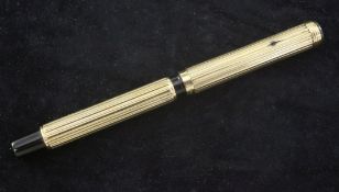 A 9ct gold Waterman's Ideal fountain pen, with reeded decoration, the cap inset with circular