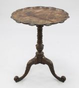 A George III style carved mahogany wine table, the circular lobed top above a blind fret carved