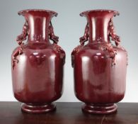 A pair of large Chinese sang-de-boeuf glazed vases, 20th century, each of bottle form with a