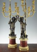 A pair of 19th century and later gilt brass and bronze figural candelabra, 35in. A pair of 19th