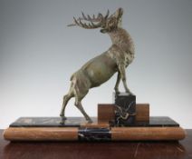 A French Art Deco patinated metal figure of a stag, 25in. A French Art Deco patinated metal figure