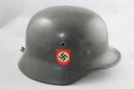 A German Third Reich M40 combat police helmet, A German Third Reich M40 combat police helmet, with