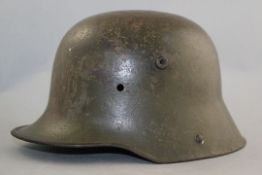 A German WWI M16 helmet, A German WWI M16 helmet, with green paint, no liner or chin strap