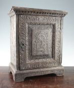 A carved oak cabinet, W.1ft 3in. A carved oak cabinet, with single panelled door opening to reveal a