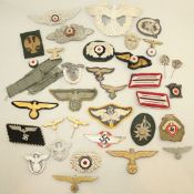 A collection of various German Third Reich cap badges, cloth badges and pins A collection of various