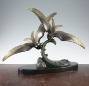 Trebig. An Art Deco patinated bronze group of two seagulls flying over a wave, 16.5in. Trebig. An