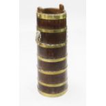 A tall oak barrelled stick stand, 28.5in. A tall oak barrelled stick stand, brass bound with lion