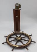 A teak eight spoke ship's wheel on an octagonal mahogany column, 43.5in. A teak eight spoke ship's