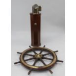 A teak eight spoke ship's wheel on an octagonal mahogany column, 43.5in. A teak eight spoke ship's