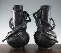 A pair of Art Nouveau black painted metal figural vases, both 18in. A pair of Art Nouveau black