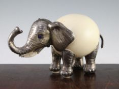 Gabriella Binazzi, Italian. An ostrich egg model elephant, with silver plated mounts and ivory