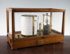 An oak case Negretti and Zambra barograph, the base with single pull out drawer for charts and