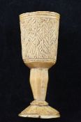 A 19th century or earlier African ivory goblet, with carved geometric decoration, 4.25in.