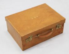 An Asprey's of London tan leather vanity case, with fold down front, spaces and compartments for