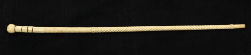 A 19th century scrimshaw carved whale bone and baleen walking cane, with tapering spiral shaft