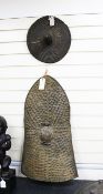 Two African shields, including a West African tamberma circular shield and an animal hide shield,