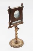 A George III mahogany zograscope, with rectangular mirror glass, adjustable column and turned