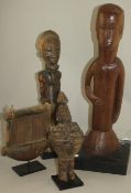 An African Ivory Coast Baule figure of a standing male, a smaller Yaka power figure, a large Papua