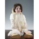 A large Simon Halbig bisque headed doll, with open mouth and teeth, with jointed composite body,