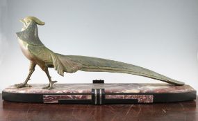 A large French Art Deco patinated model of a pheasant, on a black and rouge marble stepped plinth