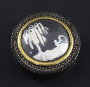 A 19th century green lacquered gold pique work circular snuff box, the lid inset with a carved ivory