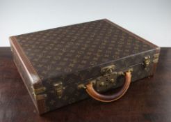 A Louis Vuitton leather briefcase, serial no.1059657, with brass fittings and swing handle, 17.5in.