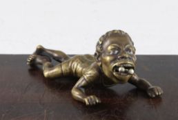 A late 19th century bronze cigar cutter, modelled as negro boy lying on his front with cigar