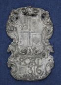 A late 17th century cartouche shape armorial wall plaque, modelled as quartered shield with sword to