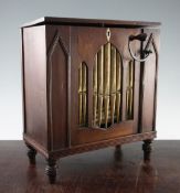 An early 19th century mahogany barrel organ, with bone lozenge shaped key escutcheon and gothic