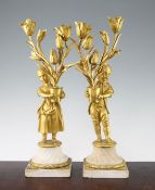 A pair of 19th century Louis XVI style gilt bronze and white marble candelabra, with a boy and