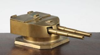 A 1920's brass twin bottle inkstand, modelled as a revolving gun turret, the lid interior marked '