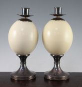 Anthony Redmile. A pair of ostrich egg candlesticks, with silver plated mounts and reeded circular