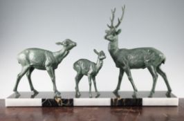 A French Art Deco patinated bronze group modelled as a family of three deer, unsigned, on a