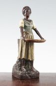 An Austrian cold painted terracotta spill vase, modelled as an African female standing and holding a