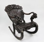 A Japanese dragon carved rocking chair, with open arms and fluted seat and Art Nouveau style