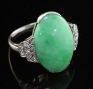 An 18ct white gold, cabochon jadeite and diamond set ring, of oval form, size O.